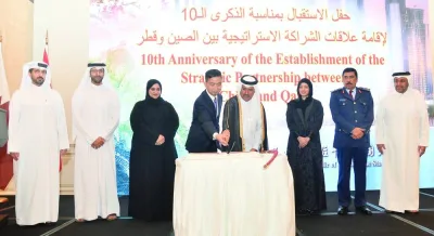 Chinese ambassador Cao Xiaolin is joined by Qatar&#039;s Ministry of Foreign Affairs Secretary-General HE Dr Ahmed bin Hassan al-Hammadi in cutting a cake on the occasion. PICTURES: Shaji Kayamkulam.
