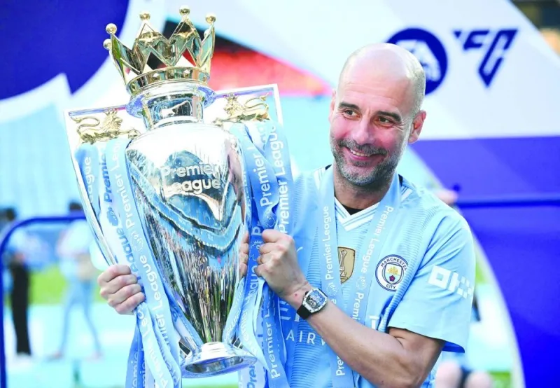 
Manchester City’s Spanish manager Pep Guardiola poses with the Premier League trophy after the presentation ceremony following his team’s win against West Ham United in Manchester on Sunday. (AFP) 