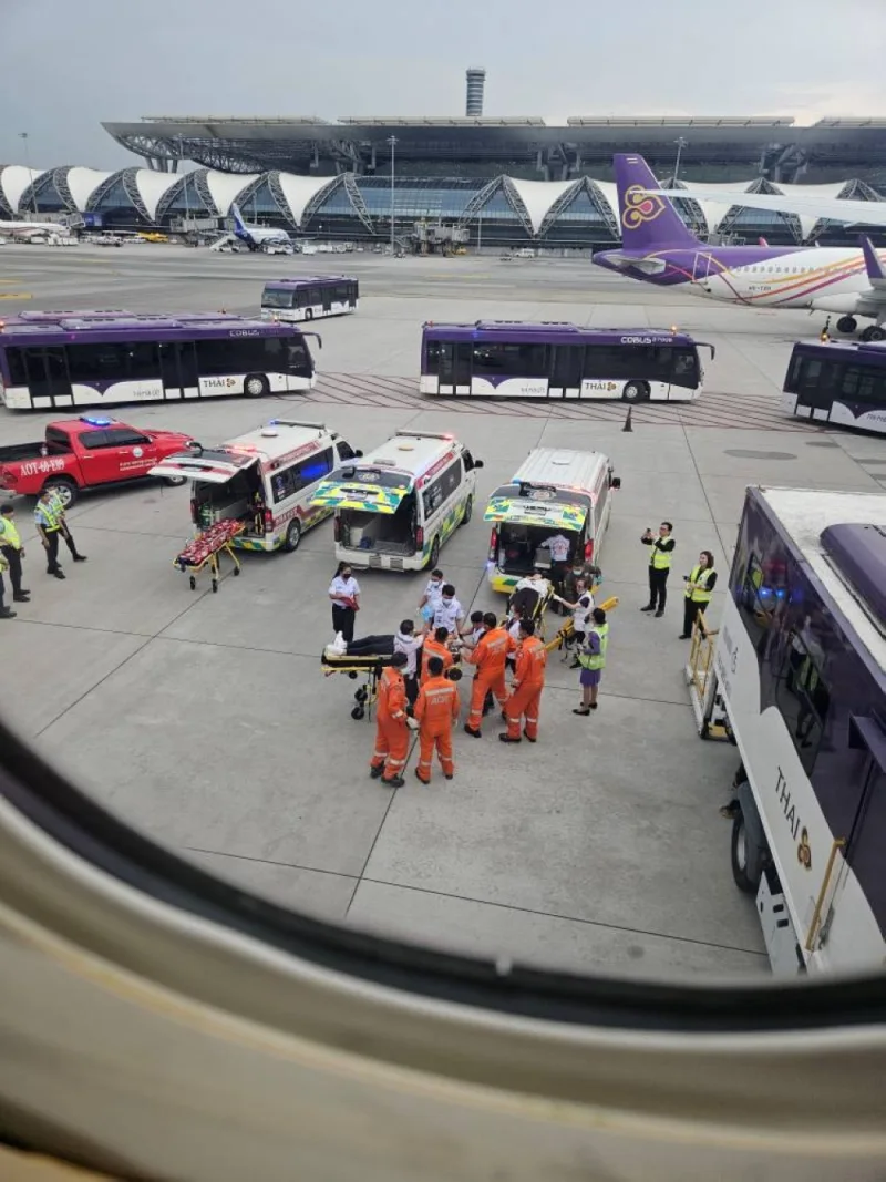 Staff member carry people on stretchers after an emergency landing at Bangkok&#039;s Suvarnabhumi International Airport, in Bangkok, Thailand on Tuesday.  Obtained by Reuters/Handout via REUTERS