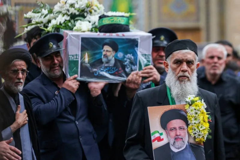 A member of a honour guards weeps while carrying the coffin of Iran&#039;s President Ebrahim Raisi during a funeral procession in Qom, on Tuesday. 