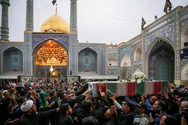 Mourners attend the funeral procession of Iran&#039;s President Ebrahim Raisi at a Muslim Shiite Shrine in Qom, on Tuesday.