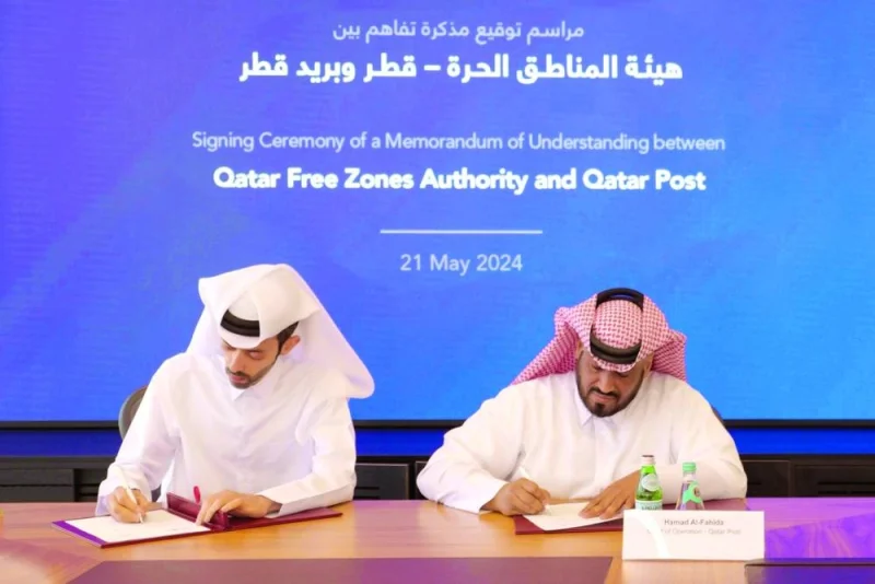 Abdulla Hamad al-Binali, director of Investor Relations and Technical Support at QFZ, and Hamad al-Fahida, chief operating officer of Qatar Post, signing the agreement during a ceremony at the Business Innovation Park in Ras Bufontas Free Zone.