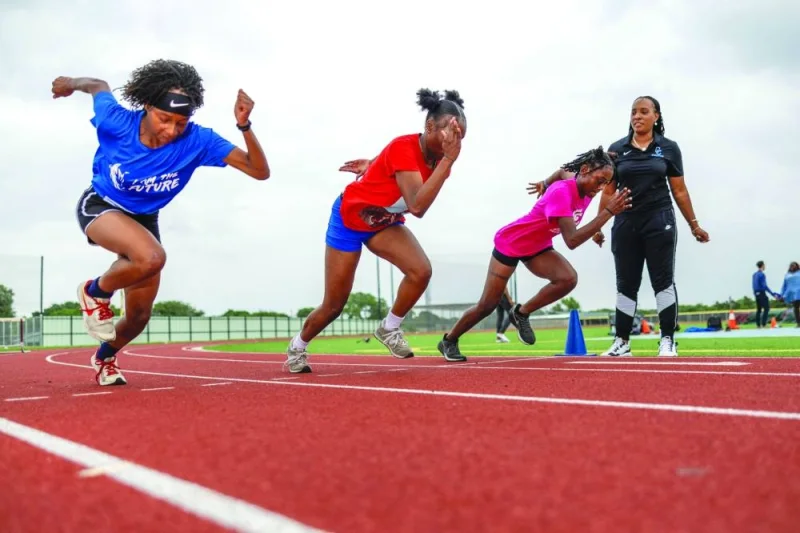
Student athletes practice during a workout with Dallas Carter High School girls track and field coach Lauren Cross (right) at the Sha’Carri Richardson Track at John E. Kincaide Stadium in Dallas, Texas, on May, 6, 2024. (AFP) 