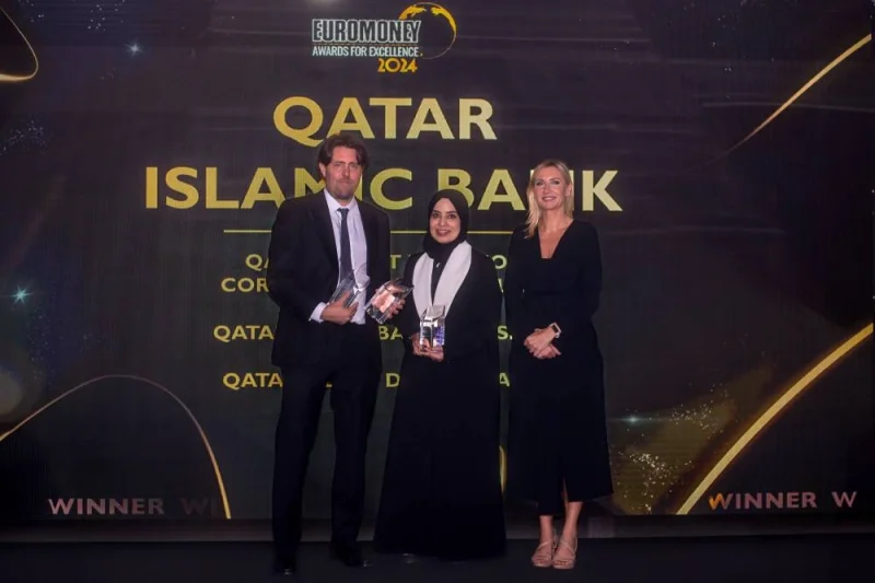 Mashaal Abdulaziz al-Derham, assistant general manager, head of Corporate Communications and Quality Assurance at QIB, receiving the awards at the ceremony held in Dubai recently.