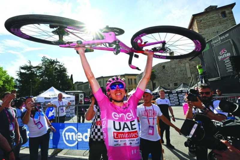 
Team UAE rider Tadej Pogacar wearing the overall leader’s pink jersey celebrates after crossing the finish line to win the 20th stage of the 107th Giro d’Italia in Bassano del Grappa. (AFP) 