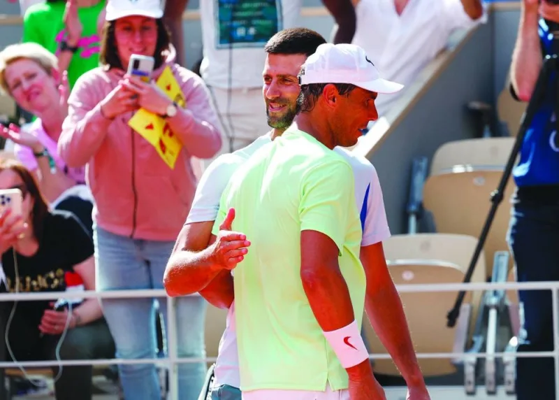 Serbia’s Novak Djokovic hugs Spain’s Rafael Nadal during a practice session on Sunday.