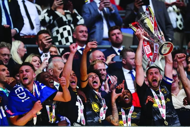 Southampton’s Jack Stephens lifts the trophy after defeating Leeds United in the English Championship play-off final at Wembley Stadium in London on Sunday. (AFP)
