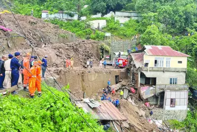 Members of rescue teams look for survivors amidst the debris next to a stone quarry that collapsed following torrential rains brought by cyclone Remal on the outskirts of Aizawl, the capital of northeastern state of Mizoram, India, yesterday.