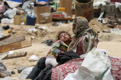 A child rests on the day Palestinians travel on foot along with their belongings, as they flee Rafah due to an Israeli military operation, in Rafah, in the southern Gaza Strip, on Tuesday. REUTERS