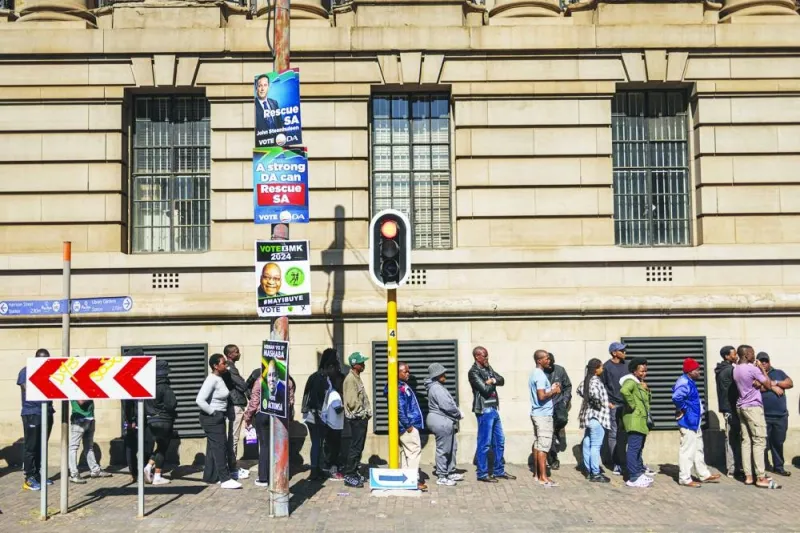 Voters wait in line outside the Johannesburg City Hall polling station in Johannesburg's Central Business District yesterday during South Africa's general election. (AFP)