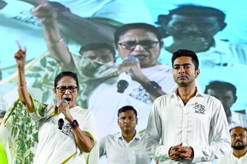 West Bengal Chief Minister and Trinamool Congress party leader Mamata Banerjee (left), addresses her supporters during an election campaign meeting of their candidate and national general secretary Abhishek Banerjee (second right) in Kolkata ahead of the seventh and final phase of voting in India's general election.
