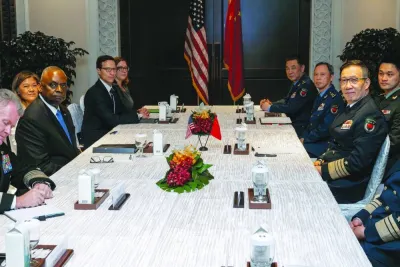 US Secretary of Defence Lloyd Austin and Chinese Defence Minister Dong Jun attend a bilateral meeting in Singapore yesterday.