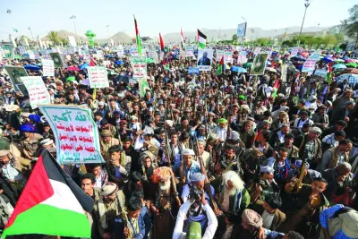 Yemenis wave Palestinian flags during a march in the Houthi-run capital Sanaa in solidarity with the people of Gaza, yesterday.