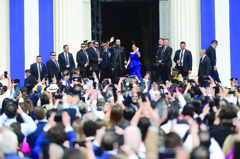 
Bukele waves to the audience beside his wife Gabriela on the day of his swearing-in ceremony for a second term, in San Salvador. 
