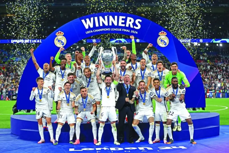 Real Madrid’s Nacho lifts the trophy as he celebrate with teammates after winning the Champions League at Wembley stadium in London on Saturday. (Reuters)