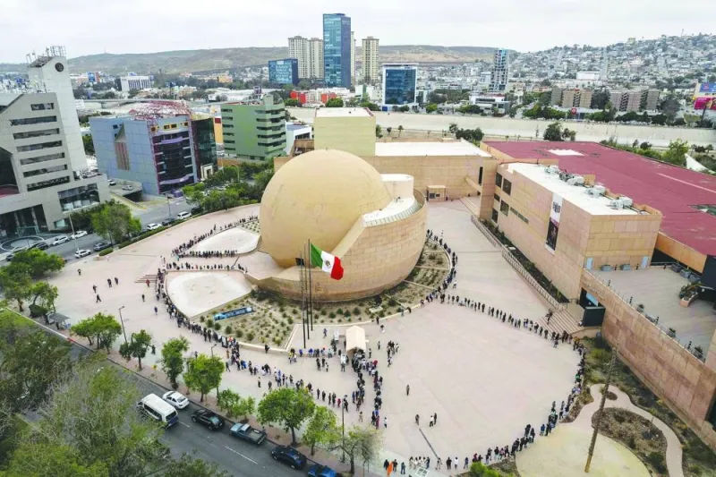 
Aerial view showing people queueing to cast their vote on a special polling station at Centro Cultural Tijuana, in Tijuana, Baja California state, Mexico. 