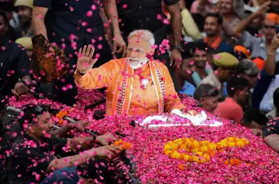 Indian Prime Minister and leader of the Bharatiya Janata Party (BJP) Narendra Modi gestures during a roadshow in Varanasi on April 25, 2019.  AFP