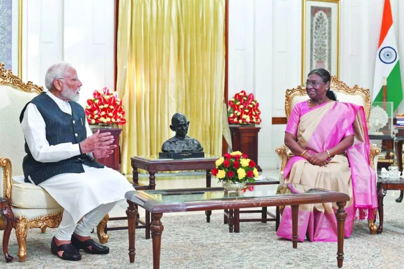 President Droupadi Murmu speaks with Prime Minister Narendra Modi after he was elected for his third term following the country's general election, at the presidential palace, Rashtrapati Bhavan, in New Delhi.