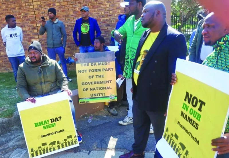 ANC supporters holds placards protesting against partnering with the DA, outside the National Executive Committee talks (NEC) in Boksburg, in the East of Johannesburg.