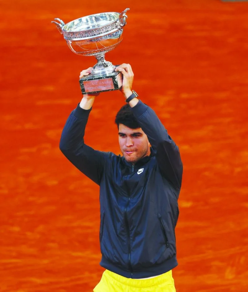 Spain’s Carlos Alcaraz celebrates with the trophy after winning the French Open final against Germany’s Alexander Zverev in Paris on Sunday. (Reuters)