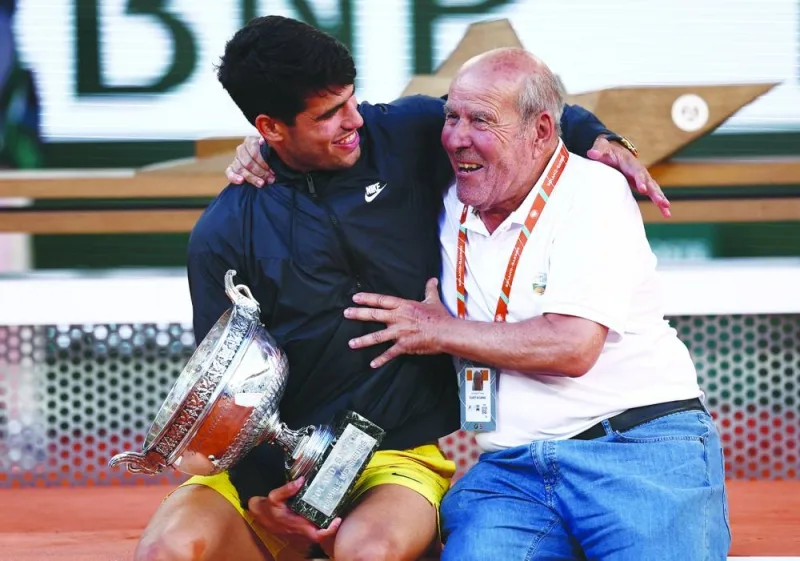 Carlos Alcaraz celebrates with his grandfather after winning the French Open on Sunday. (Reuters)