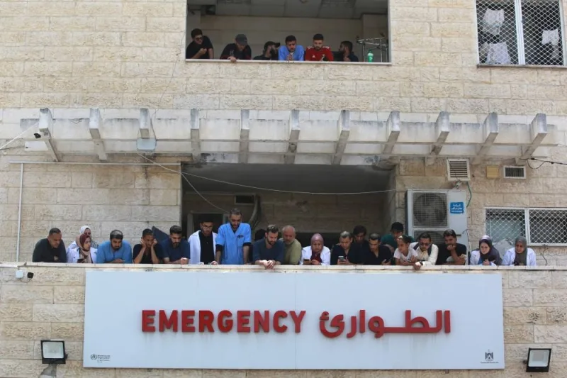 Medics and nurses wait and watch for the arrival of injured and killed Palestinian to the al-Aqsa Martyrs Hospital in Deir al-Balah, in the central Gaza Strip, following the Israeli bombardment of a residential apartment in Deir al-Balah on Saturday. AFP