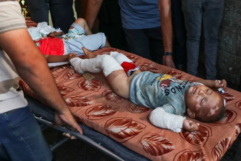 Wounded Palestinian children are carried on stretchers, after an Israeli strike at Al-Aqsa Martyrs Hospital in Deir Al-Balah, in the central Gaza Strip, on Saturday. REUTERS