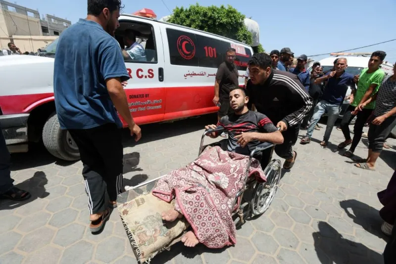 A Palestinian man is pushed on a wheelchair in the aftermath of an Israeli strike at Al-Aqsa Martyrs Hospital in Deir Al-Balah, in the central Gaza Strip, Saturday. REUTERS