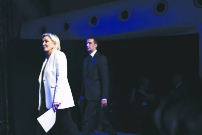 Rassemblement National party leader Marine Le Pen (left) followed by party President Jordan Bardella arrives on stage after the French president called for new general elections during an evening gathering on the final day of the European Parliament election, at the Pavillon Chesnaie du Roy in Paris. (AFP)