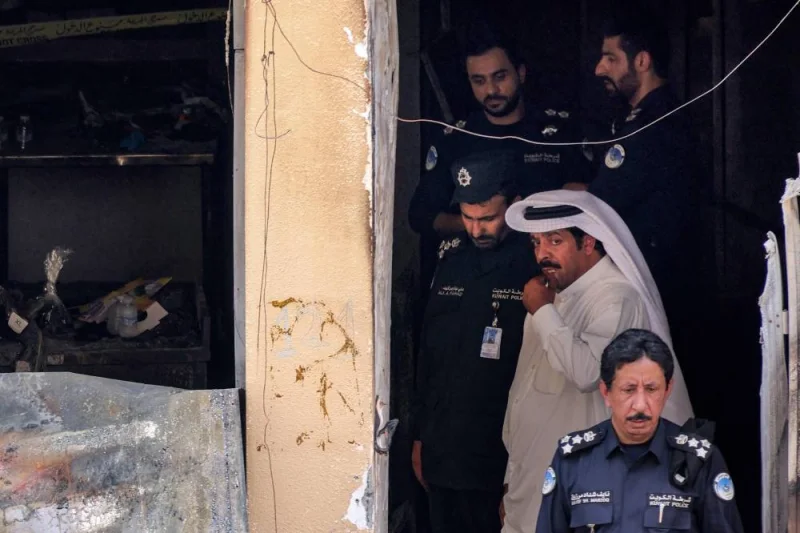 Kuwaiti security forces gather at a building which was ingulfed by fire, in Kuwait City, on Wednesday. AFP