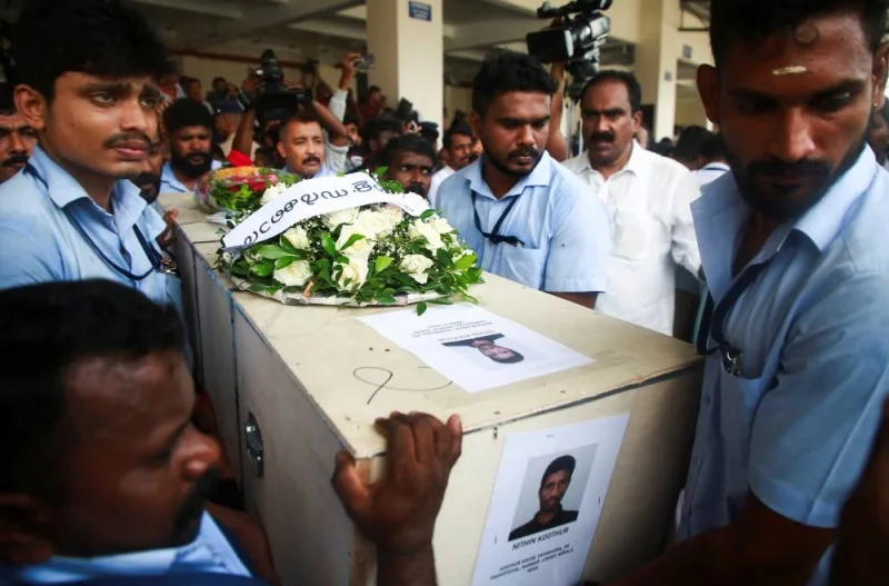 Officials carry a coffin containing the body of a victim who died during a fire that broke out in a building housing foreign workers in Kuwait, at Cochin International Airport, in Kochi, in the southern Indian state of Kerala, on Friday. Reuters