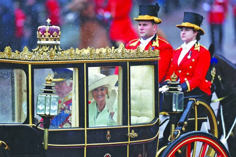 Britain's Queen Camilla waves from the Scottish State Coach on her return, along the Mall towards Buckingham Palace after the King's Birthday Parade, 'Trooping the Colour', in London.