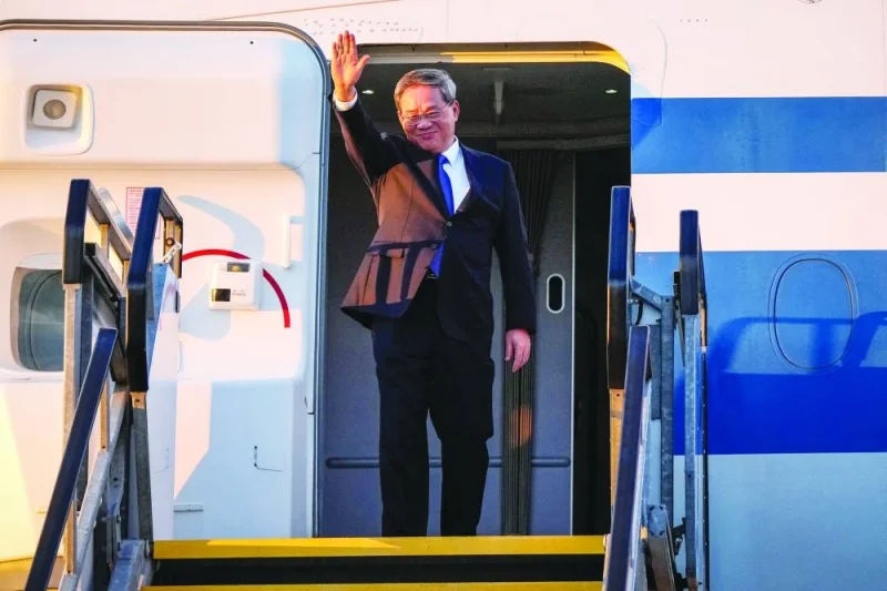 China’s Premier Li Qiang waves as he arrives at Adelaide Airport on Saturday.