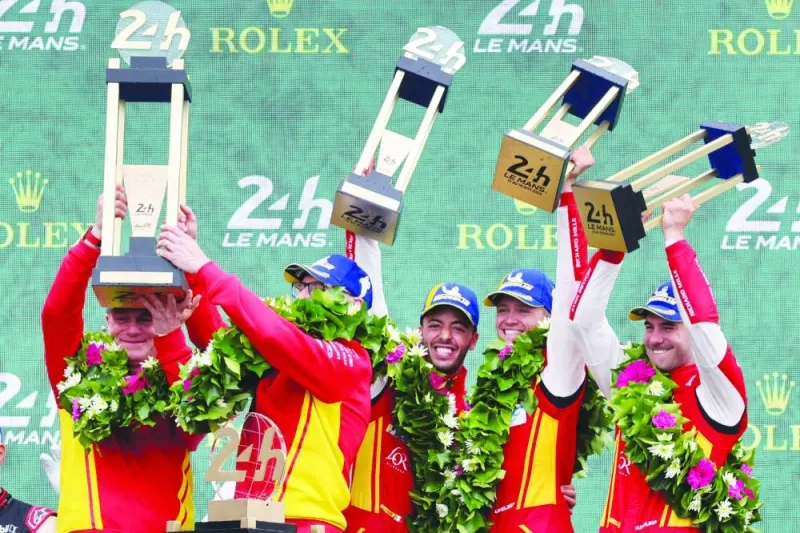(From left) Ferrari ‘s Endurance programme manager Antonello Coletta, Head of Endurance Cars Ferdinado Cannizzo and Ferrari 499P Hybrid Hypercar WEC’s drivers Antonio Fuoco of Italy, Nicklas Nielsen of Denmark and Miguel Molina (right) of Spain celebrate on the podium after winning the Le Mans 24-hours race in Le Mans, France, on Sunday. (AFP)