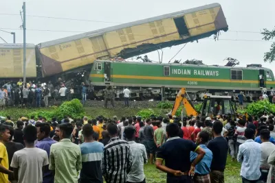 People gather near the site of a collision between an passenger and a goods train in Nirmaljote, near Rangapani station in India&#039;s West Bengal state on Monday. AFP