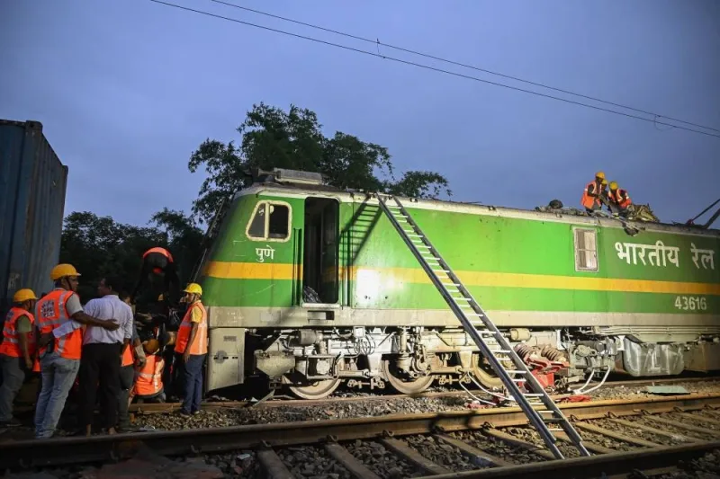 Railway workers help to restore services at the accident site following a collision between a passenger and a goods train in Nirmaljote, near Rangapani station in India's West Bengal state, on June 17, 2024. At least eight people were killed in India on June 17 when a goods train driver missed a signal and slammed into an express passenger train from behind, police and railway officials said. (Photo by DIBYANGSHU SARKAR / AFP)