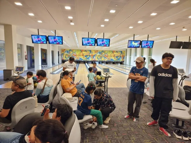 People taking part in a bowling game.