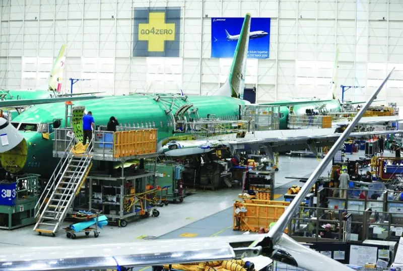 
File photo shows people working near the door of a 737 Max aircraft at the Boeing factory in Renton, Washington, US. 