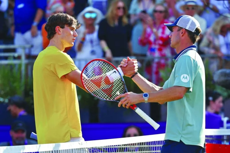 Tommy Paul (right) of the US shakes hands with Britain’s Jack Draper after winning their quarter-final of Queen’s Club Championships at the Queen’s Club, London, on Friday. (Reuters)