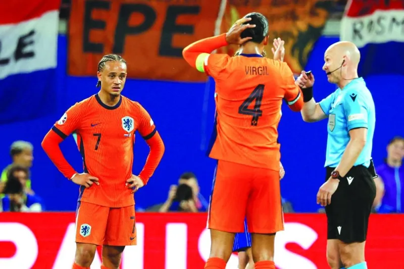 Netherlands’ forward Xavi Simons (left) reacts after the goal he scored was disallowed by English referee Anthony Taylor (right) following a VAR review during the UEFA Euro 2024 Group D match against France at the Leipzig Stadium in Leipzig on Friday. (AFP)