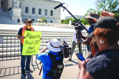 Christian Defence Coalition director Patrick Mahoney speaks to members of the media as he holds a sign that reads ‘Abusers Should NOT Own Guns!’ outside the Supreme Court in Washington, DC. – AFP