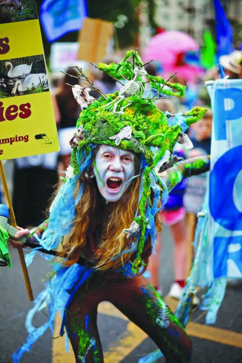 
A demonstrator with an ocean-themed outfit takes part in the “Restore Nature Now” protest. 