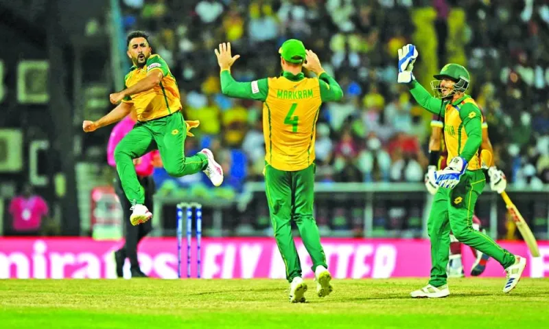 South Africa’s Tabraiz Shamsi (left) celebrates with teammates after the dismissal of West Indies’ Sherfane Rutherford during the ICC Twenty20 World Cup Super Eight match at Sir Vivian Richards Stadium in North Sound, Antigua and Barbuda on Monday. (AFP)