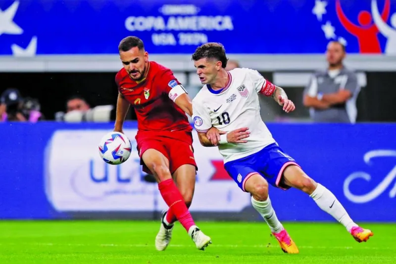 Luis Haquin of Bolivia and Christian Pulisic (right) of United States vying for the ball during the Copa America Group C match in Arlington, Texas. (AFP)