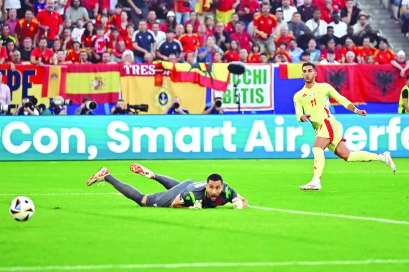 Spain’s forward Ferran Torres (right) scores a goal past Albania’s goalkeeper Thomas Strakosha during the UEFA Euro 2024 Group B match at the Duesseldorf Arena in Duesseldorf on Monday. (AFP)