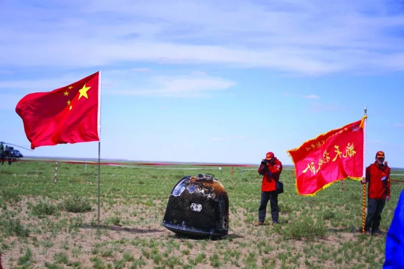 Officials prepare to recover the landing module of the Chan&#039;e-6 moon probe after it landed in Inner Mongolia, in northern China yesterday.