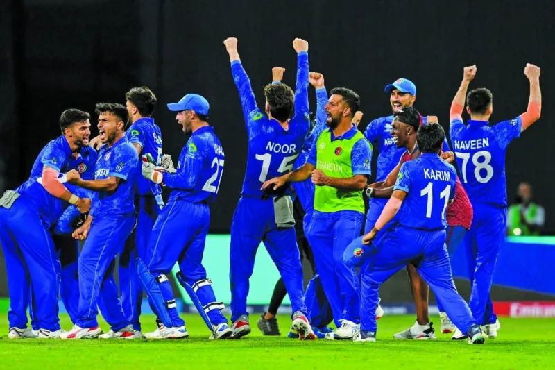 Afghanistan’s players celebrate winning their ICC Twenty20 World Cup Super Eight match against Bangladesh at Arnos Vale Stadium in Arnos Vale, Saint Vincent and the Grenadines on Tuesday. (AFP)