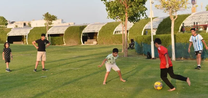 Raken (right) playing football with his friends at the UmmAl-Seneem Park yesterday.