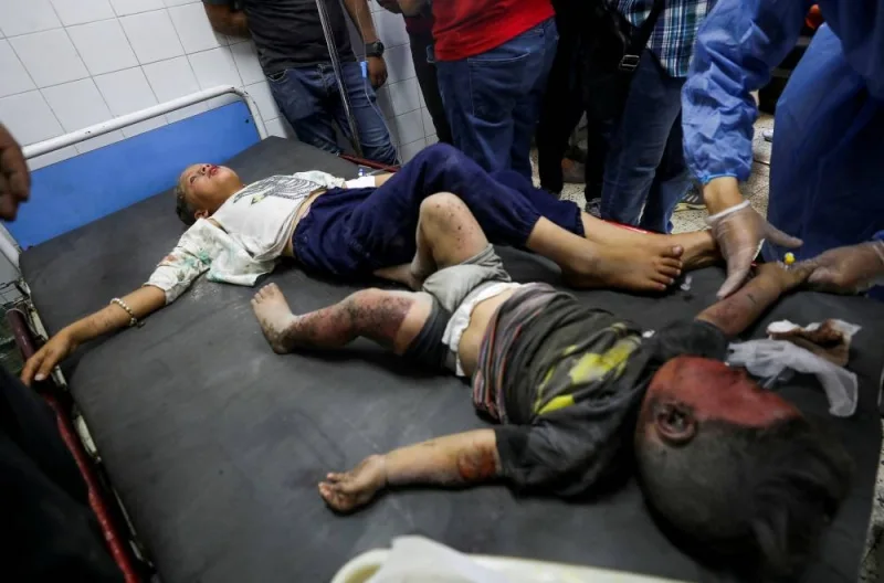 Palestinian children wounded in Israeli fire lie on a bed as they receive treatment at a hospital, following an Israeli military operation in Shejaiya in Gaza City, on Thursday. REUTERS