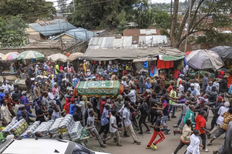 Family, friends and fellow protesters carry the body of Ibrahim Kamau, 19, in a procession as they chant slogans to show their respects in the streets of Nairobi, on Friday.